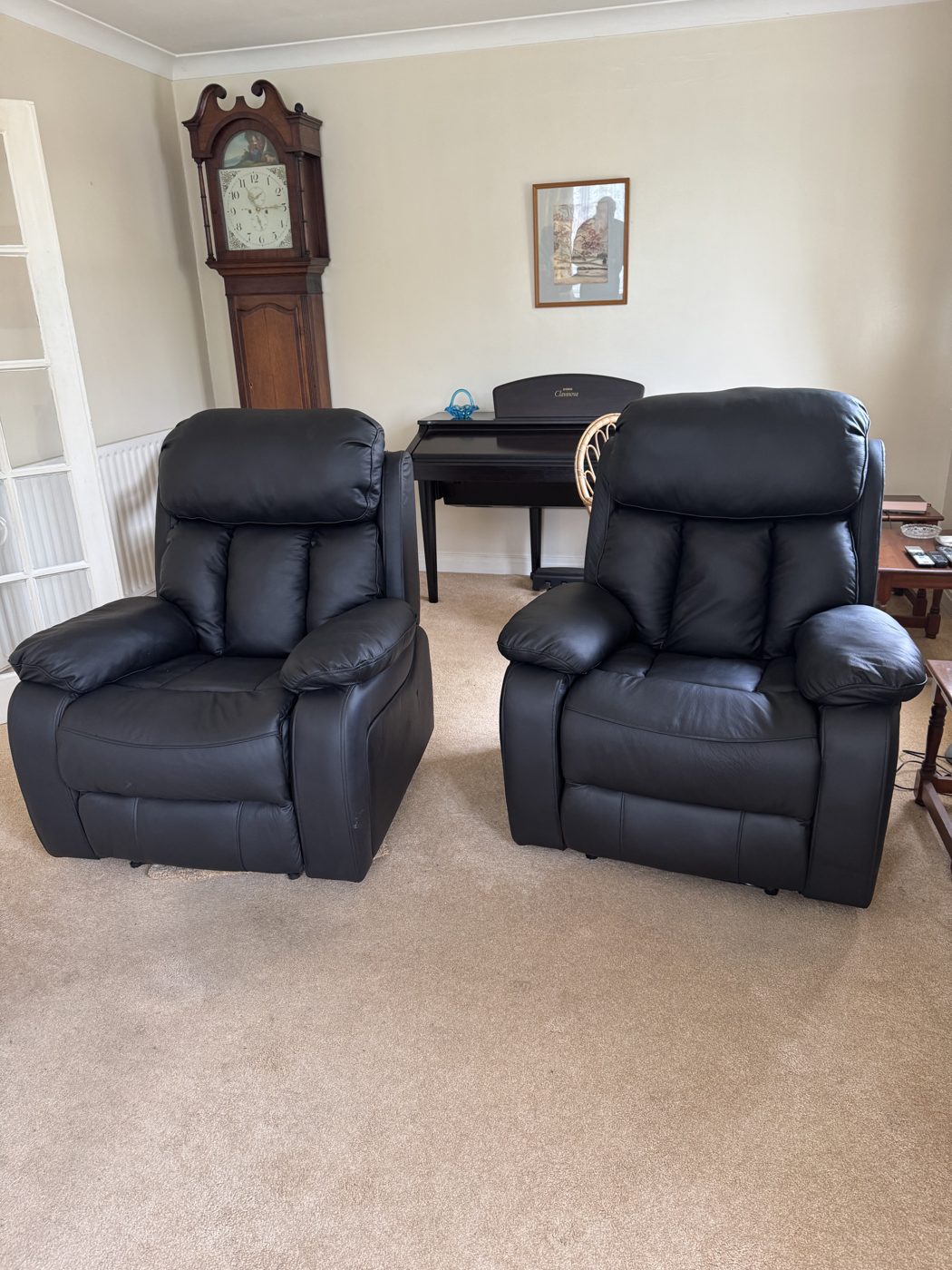 Pair of black leather recliner chairs repaired and re-covered
