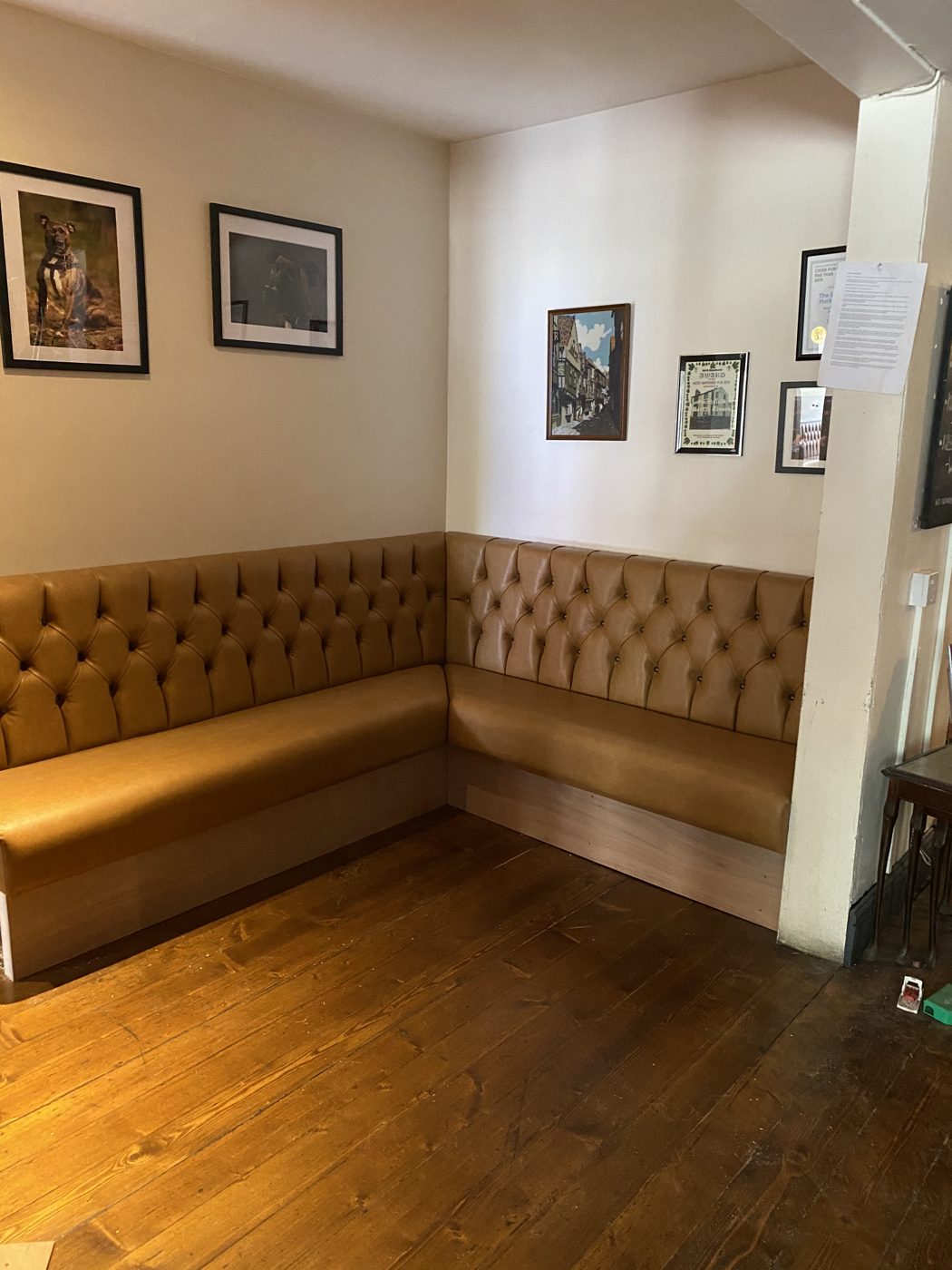 Finished pub dining corner with buttoned banquette seating