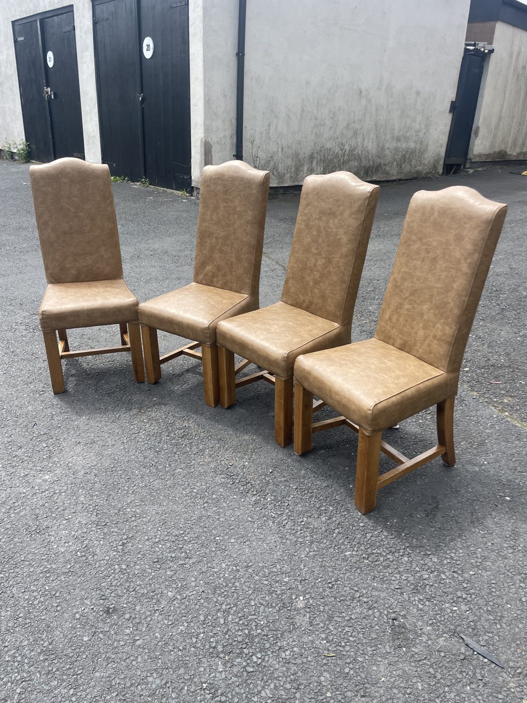 High-back restaurant dining chairs re-upholstered in tan leather