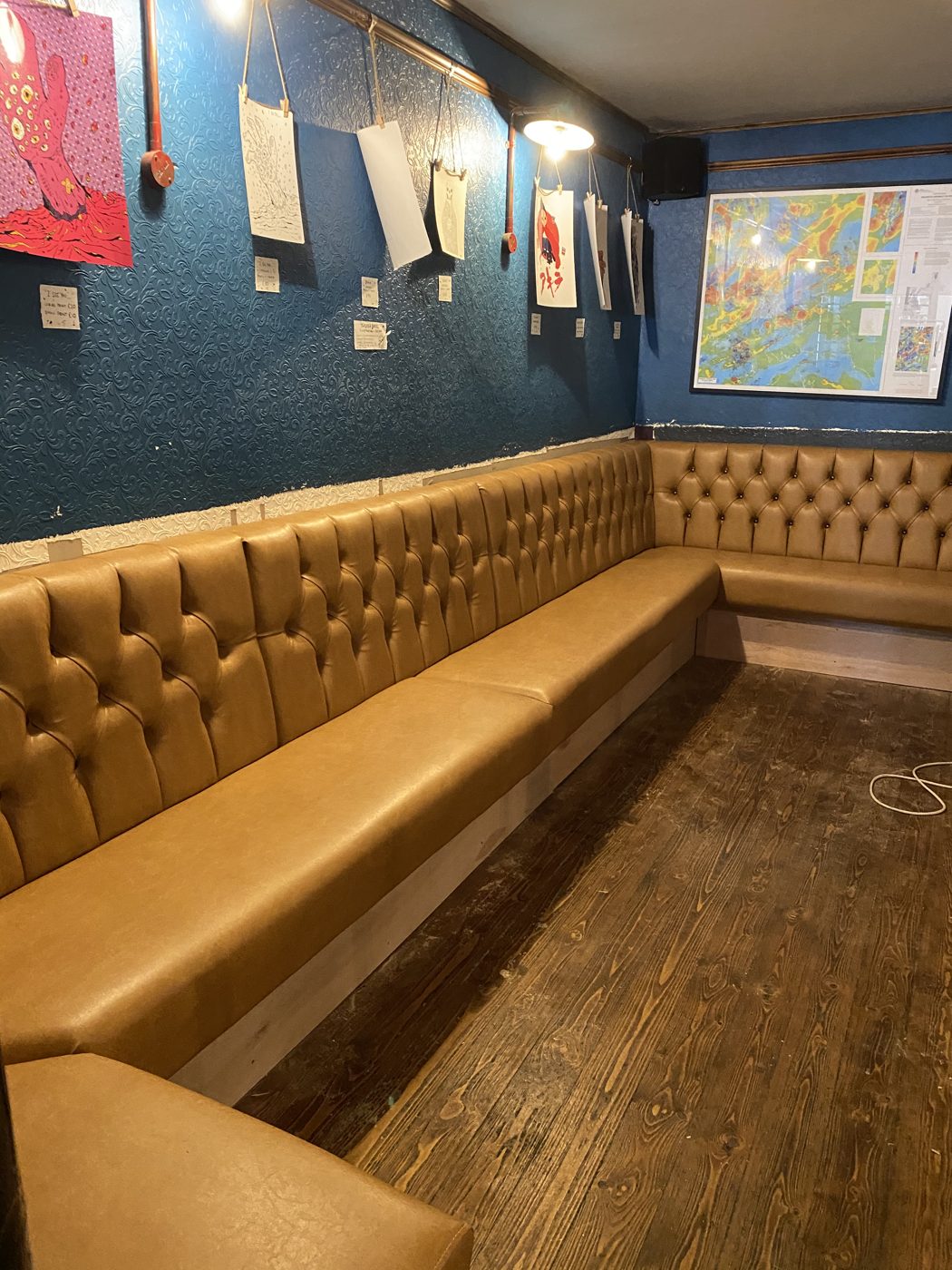 Tan buttoned chesterfield banquette seating in a pub, Lancashire